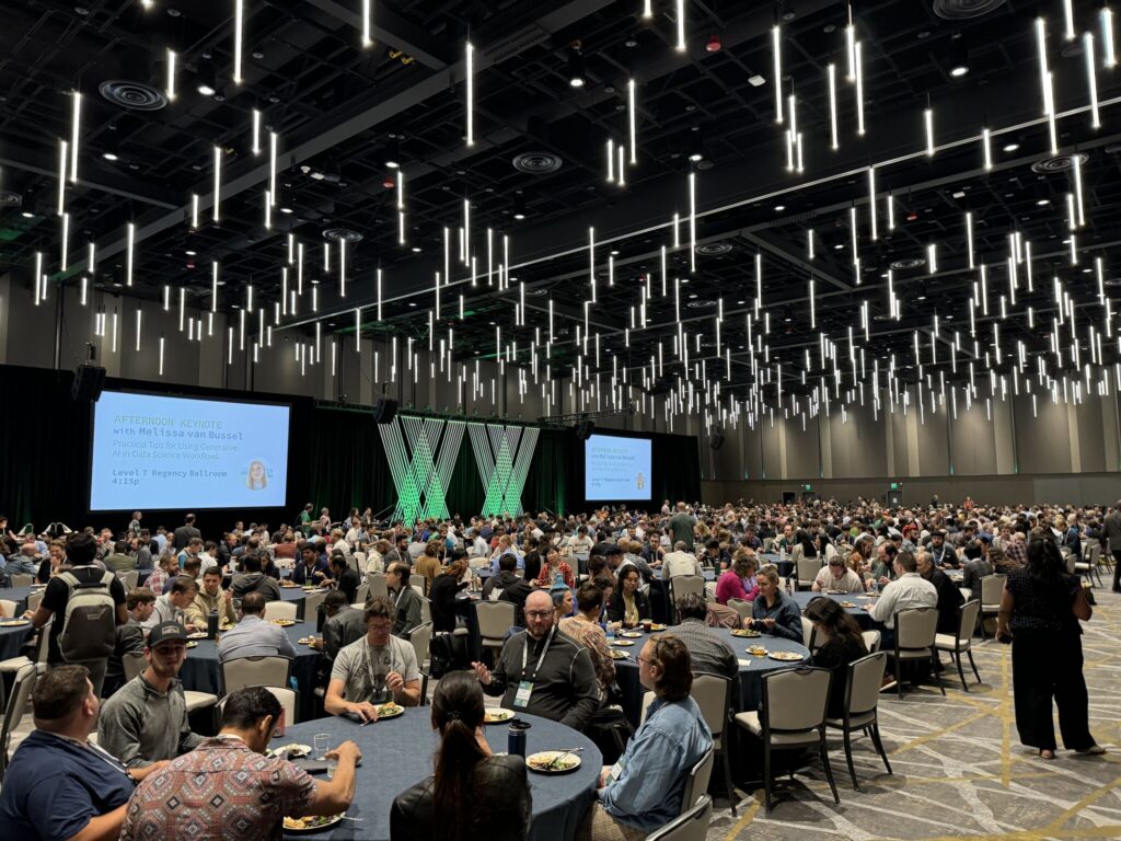 Lunch at posit::conf; large convention room with plated meals of salmon