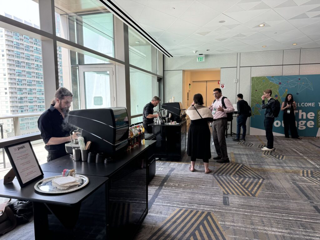 Lunch espresso area at posit::conf; two baristas at two stations making drinks